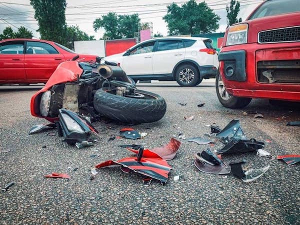 Red Motorcycle Smashed Laying On The Road