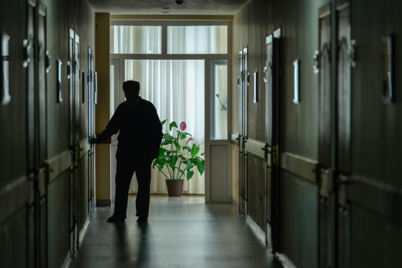 Nursing Home Hallway With A Patient At The End Of The Hallway