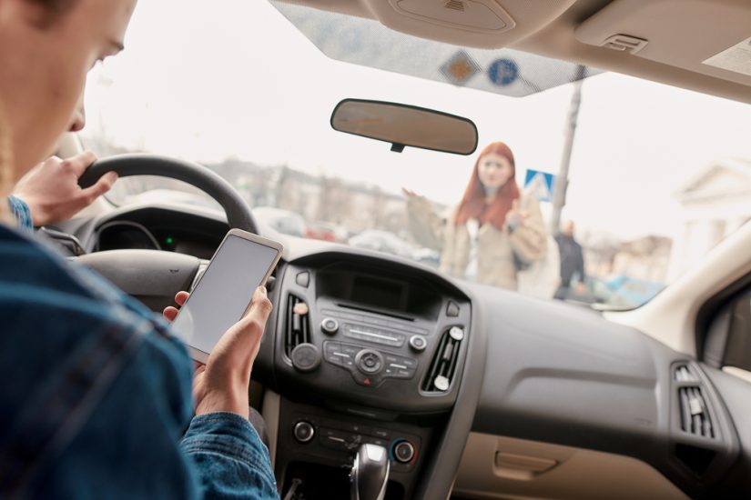 Person Using His Phone While Driving