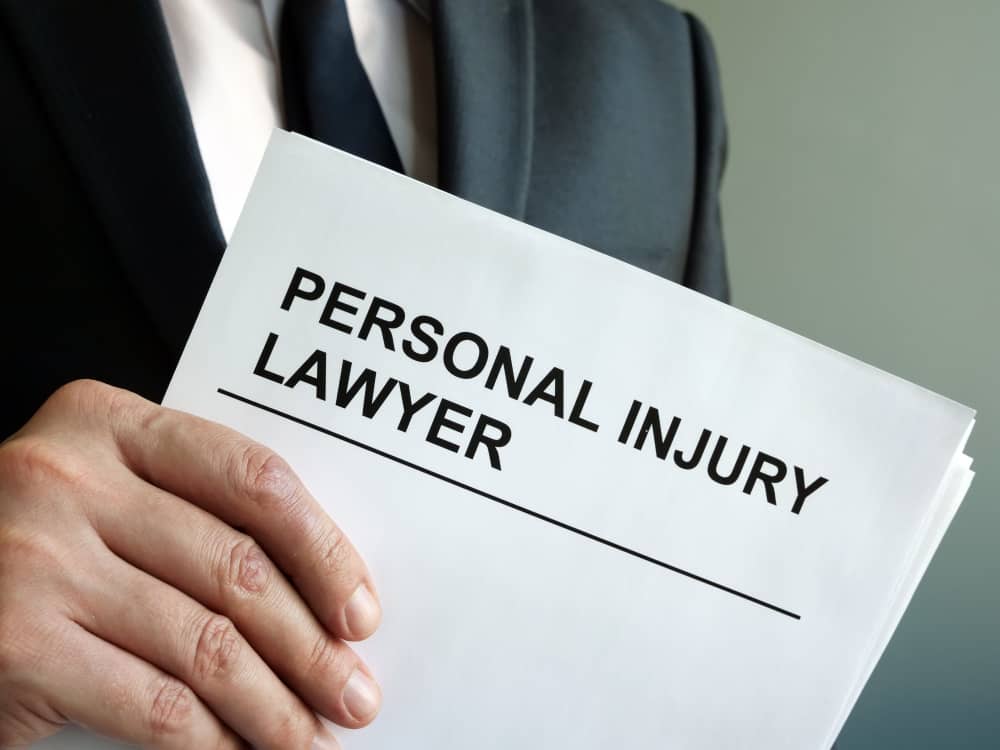 Lawyer Holding Document Titled 'Personal Injury Lawyer'